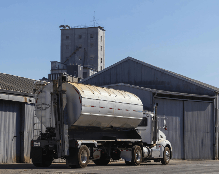 Tanker truck with feed in tank parked at farm