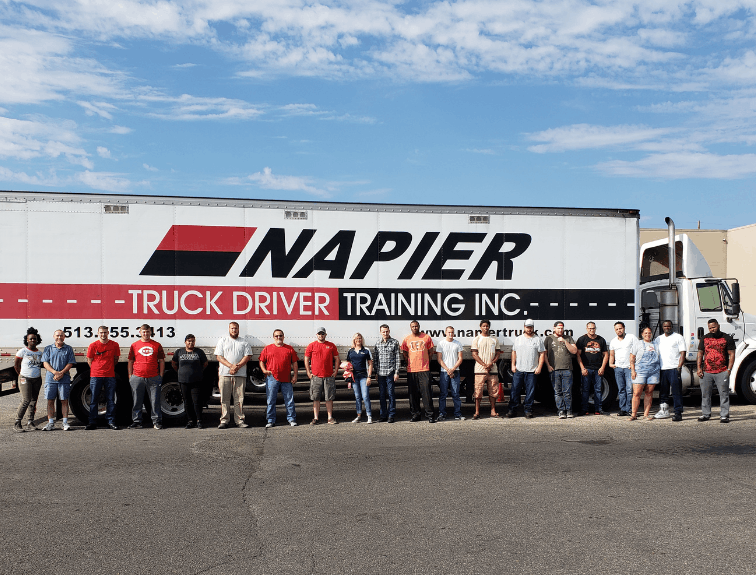 Napier grauduates standing in a line in front of Napier semi truck
