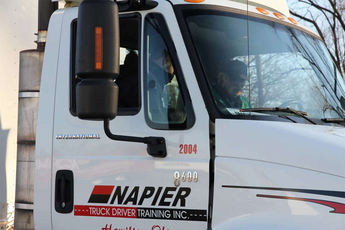 Closeup of Napier semi-truck with an instructor and student inside